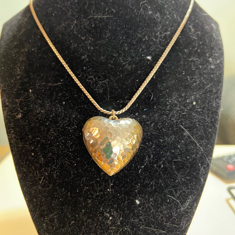 Gold-tone hammered puffy heart necklace on snake like chain. 24” long